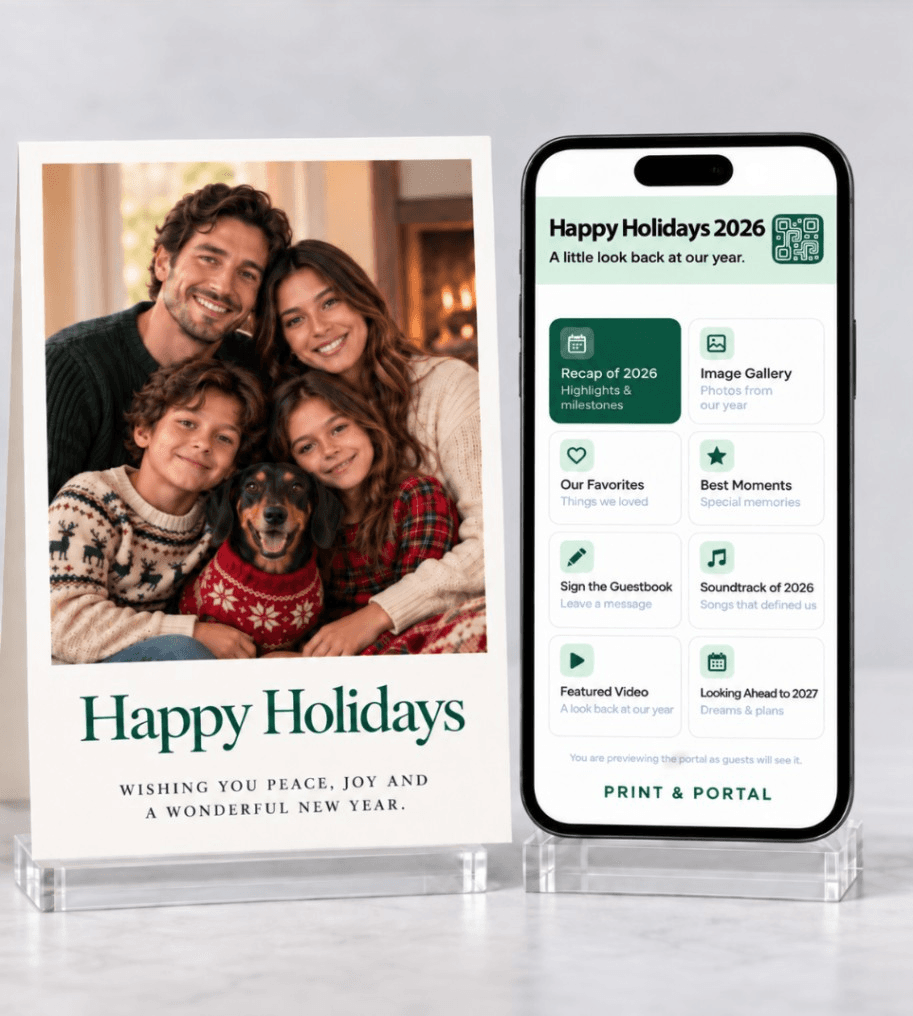 Printed Happy Holidays family photo card standing beside a phone showing its matching digital portal