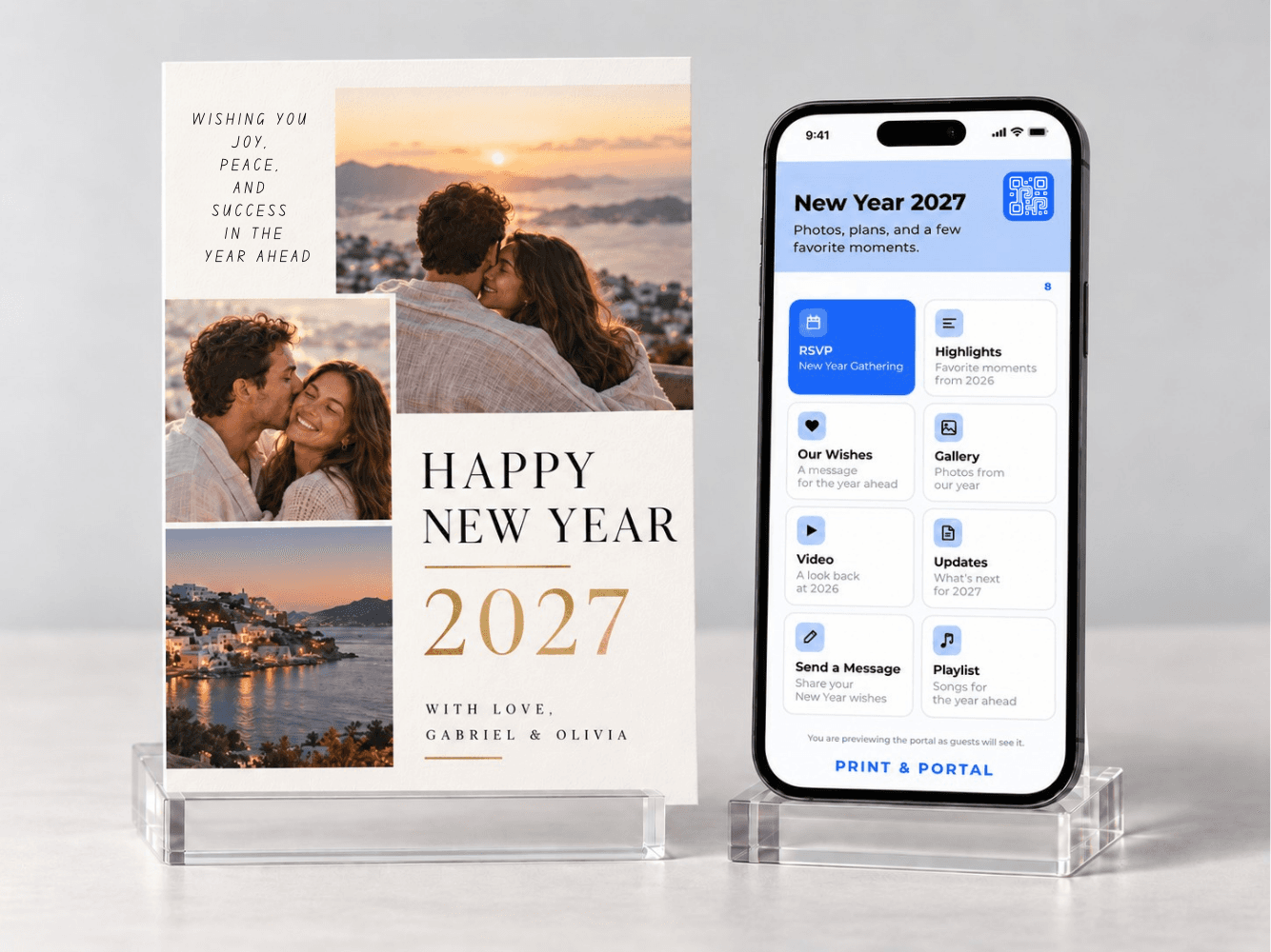 Printed Happy New Year 2027 card standing beside a phone showing its New Year portal